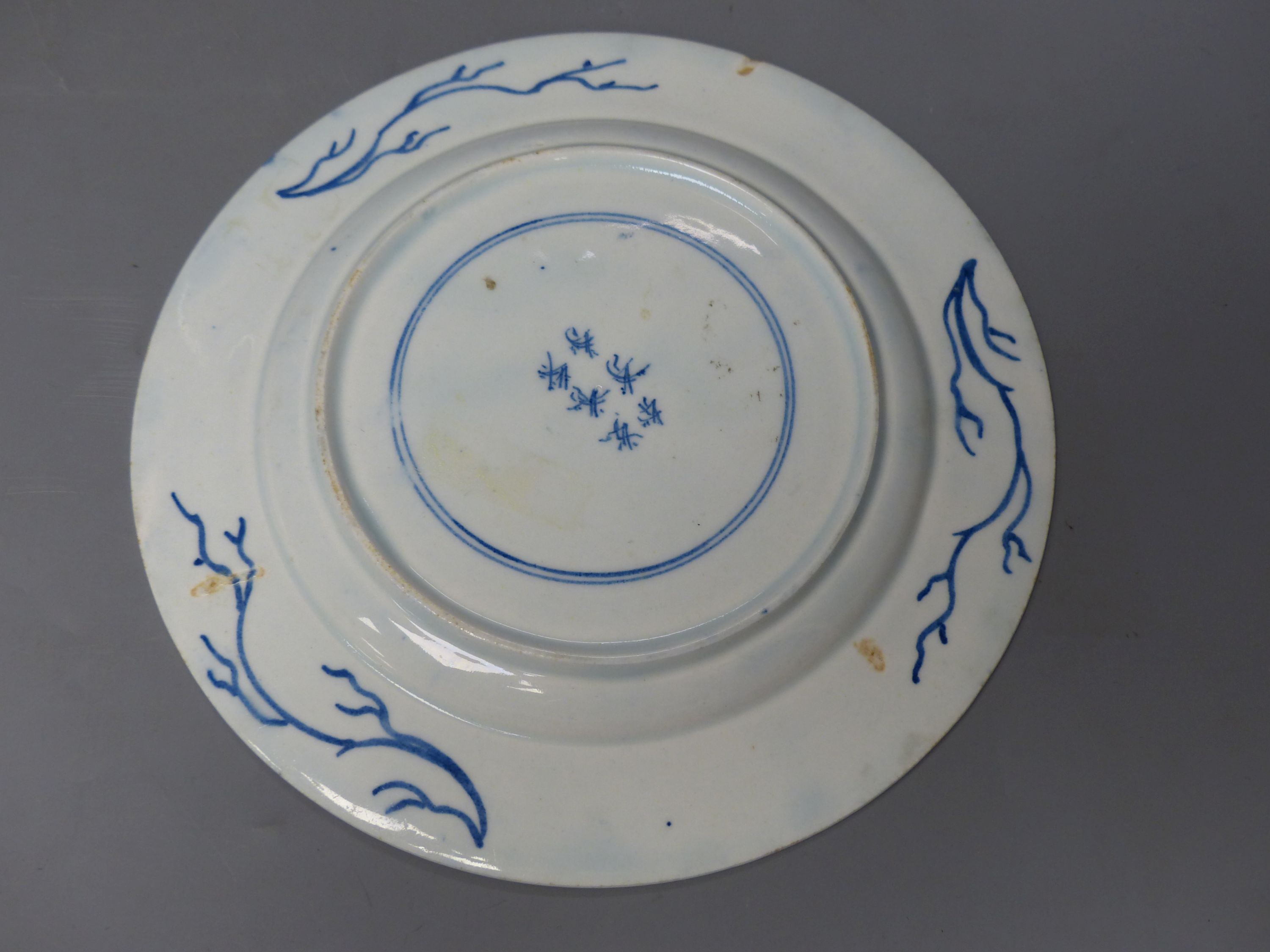 A Bow circular plate painted with landscapes, c.1757, six character mark, 20cm diameter